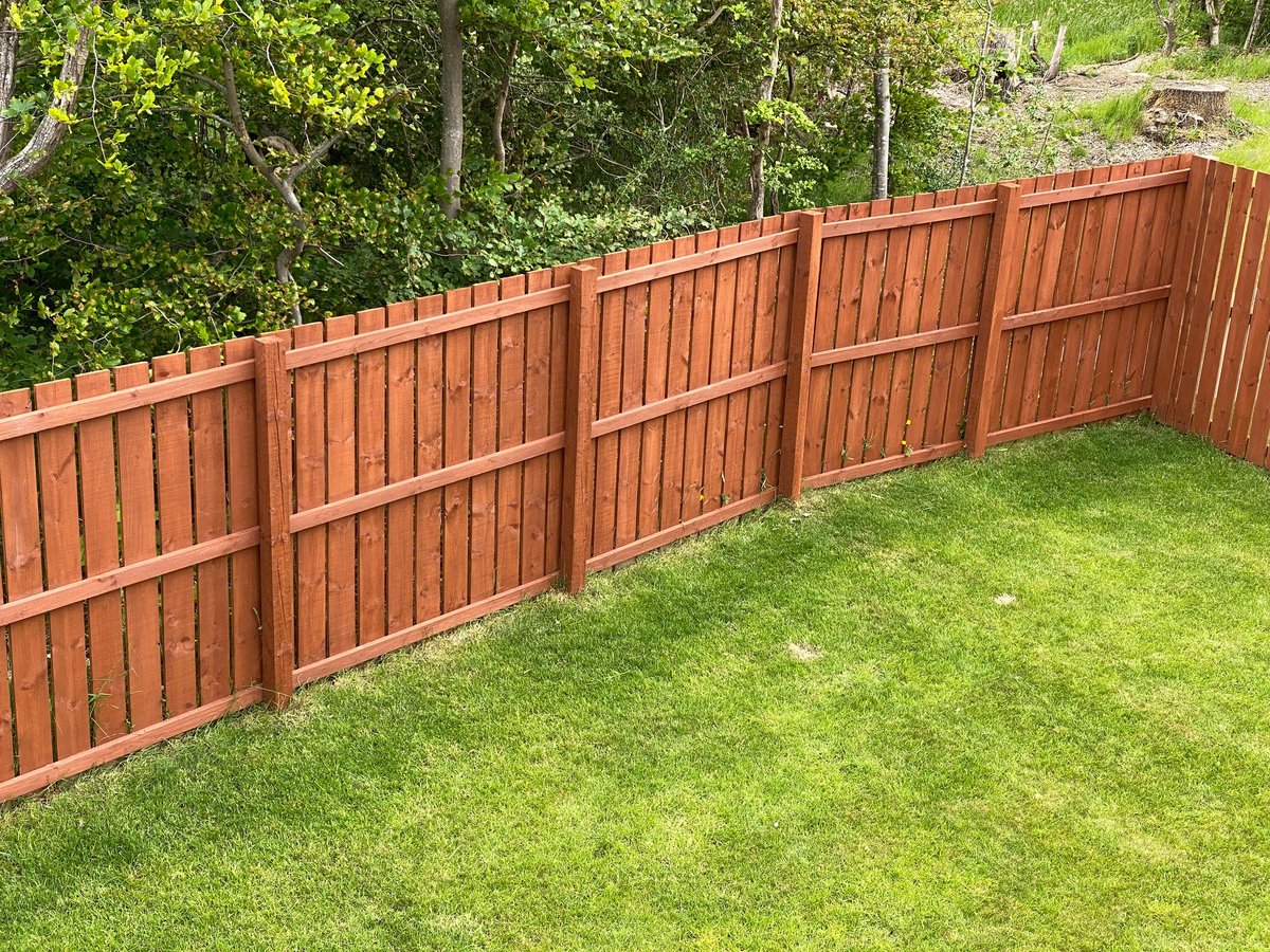 Wooden garden fence coated with medium oak colour paint, created as an independent concept for a fencing company website