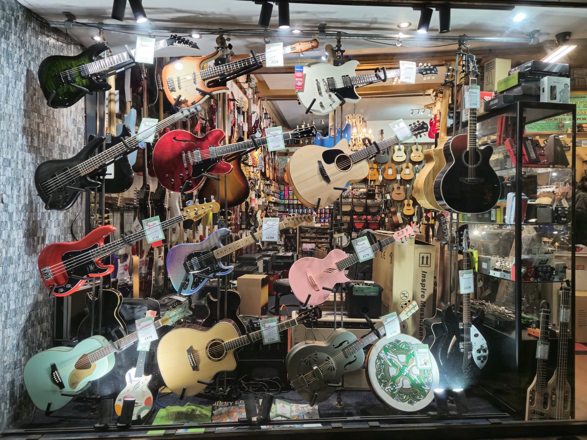 Guitars hanging on display in a musical instruments shop for a guitar retail business
