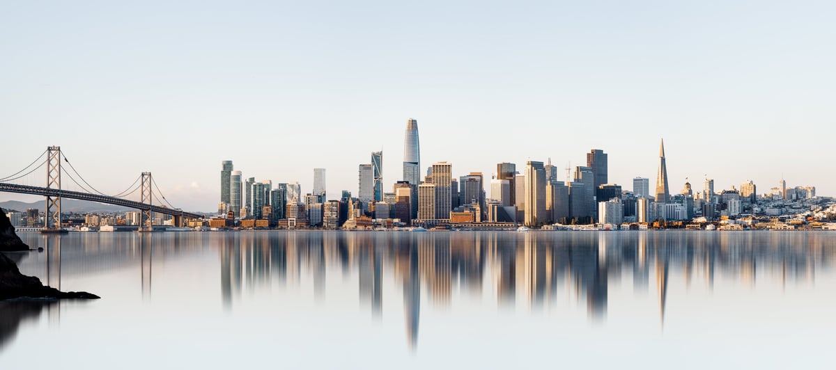The reflected skyline of a major city during sunrise representing business growth and opportunity