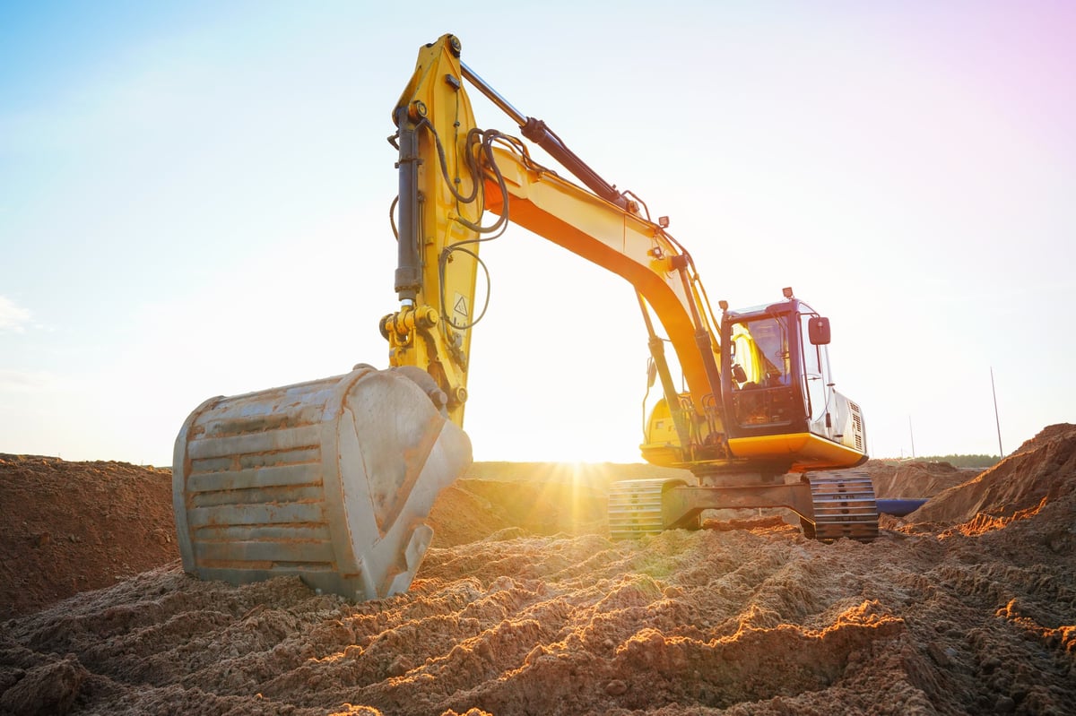 An excavator at a construction site clearing land, created as an independent concept for a land clearing company website