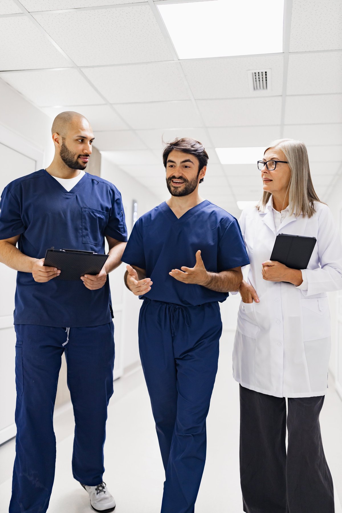 Medical professionals discussing in a clinic hallway for MedHiring Solutions healthcare staffing