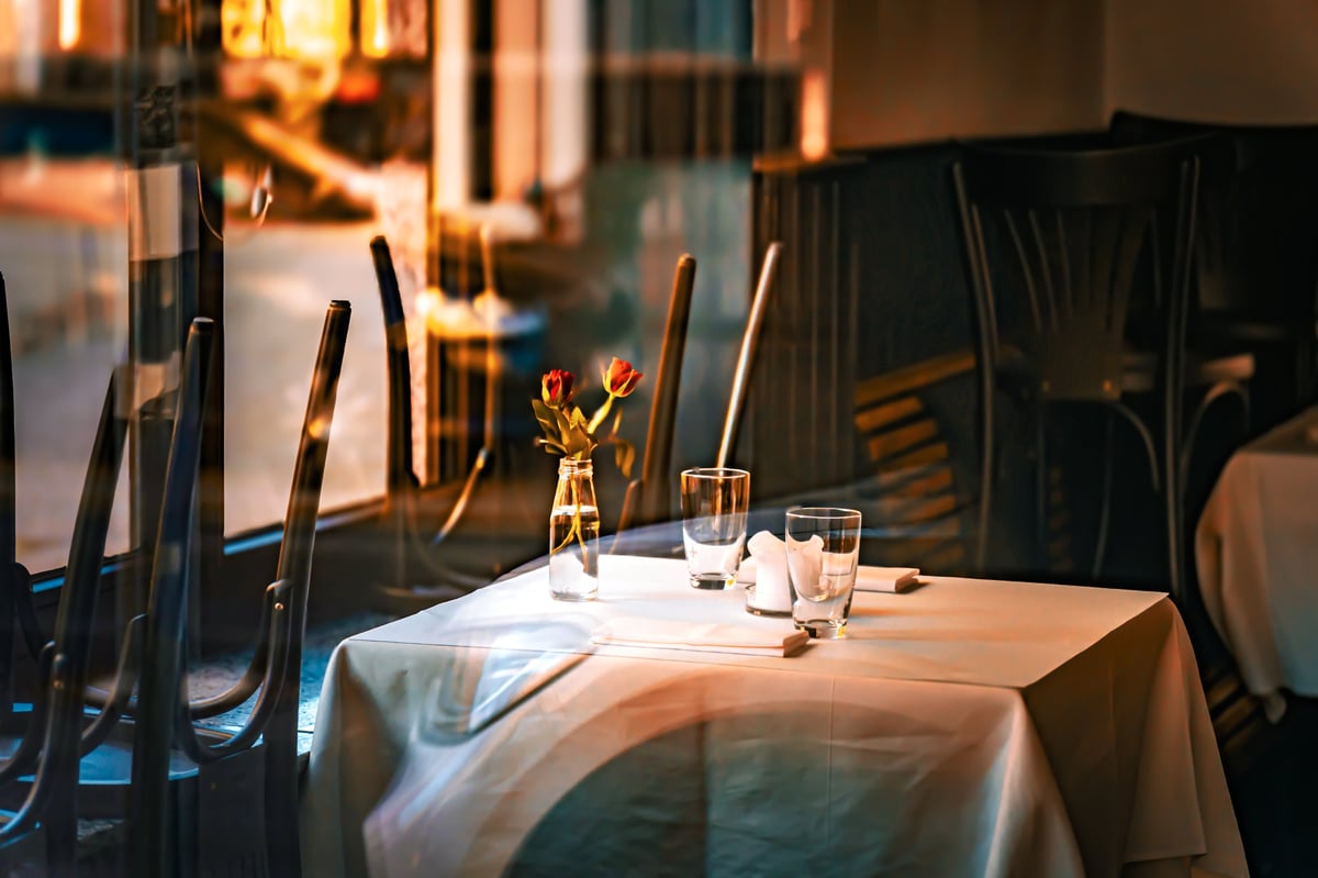 A cosy and elegant atmosphere in a modern, dark dining room, created as an independent concept for a restaurant website